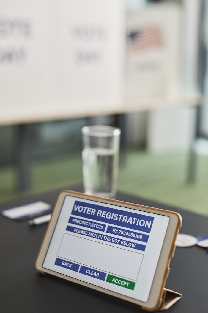 Tablet displaying voter registration screen in polling station, modern election technology.