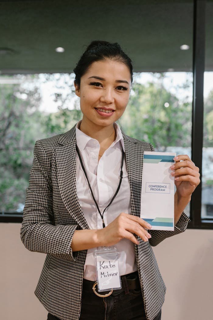 Confident businesswoman presenting a conference program indoors.